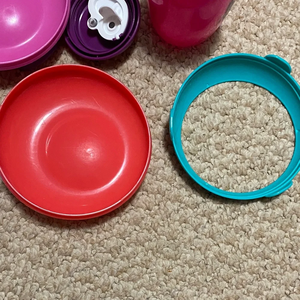 2 bibs, green & blue, 2 suction bowls, pink & purple, 1 tommie tippie sippie cup